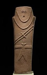 Anthropomorphic stele Arabian Peninsula. Fourth millennium B.C.E. Sandstone. Very stylized representation of a human figure, carved from stone. Has a make image and carries knives in sheaths across the chest and a knife tucked into a belt.